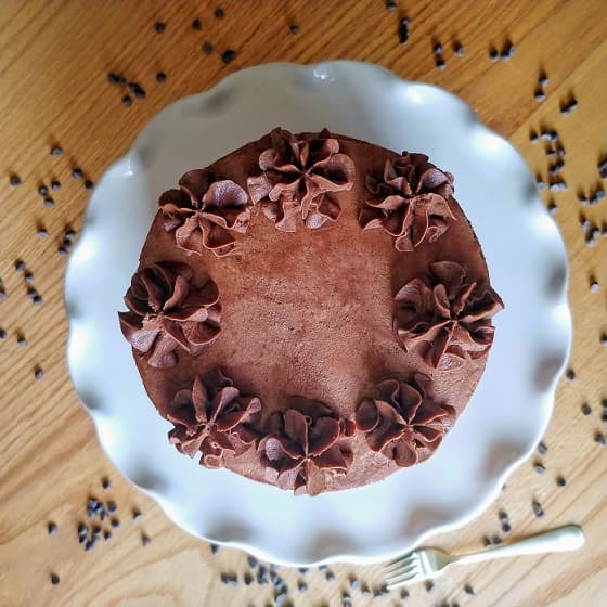 Chocolate cake on white cake stand