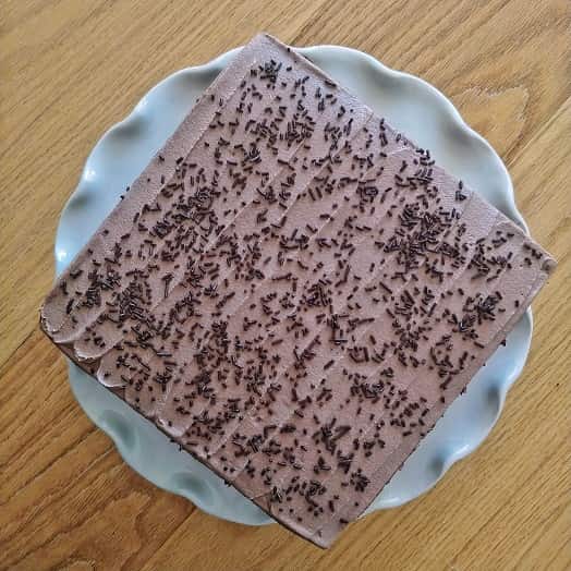 Chocolate cake on the table with chocolate sprinkles.