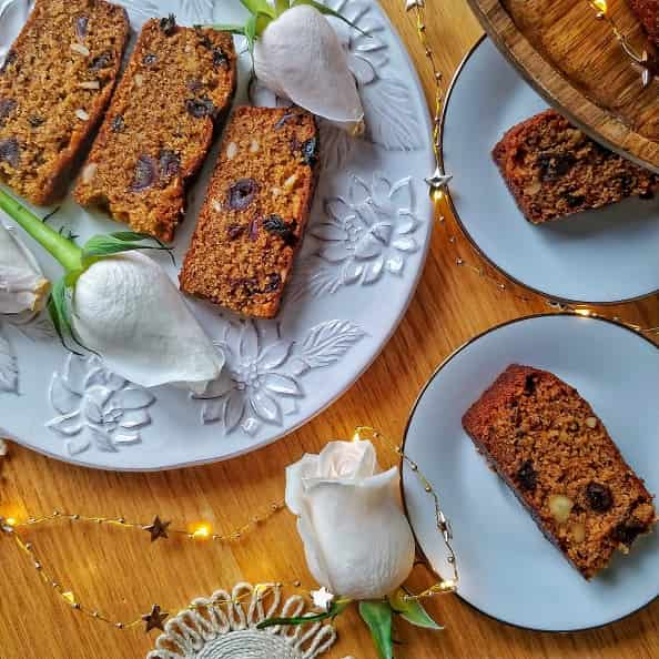 Sri Lankan Coconut Cake / Bibikkan cake slices displayed on a table with white roses.