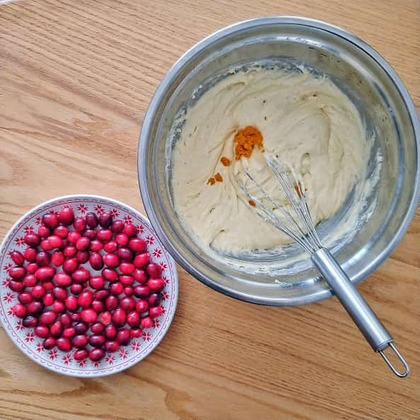 Cranberry Orange Muffin batter and orange zest with fresh cranberries.