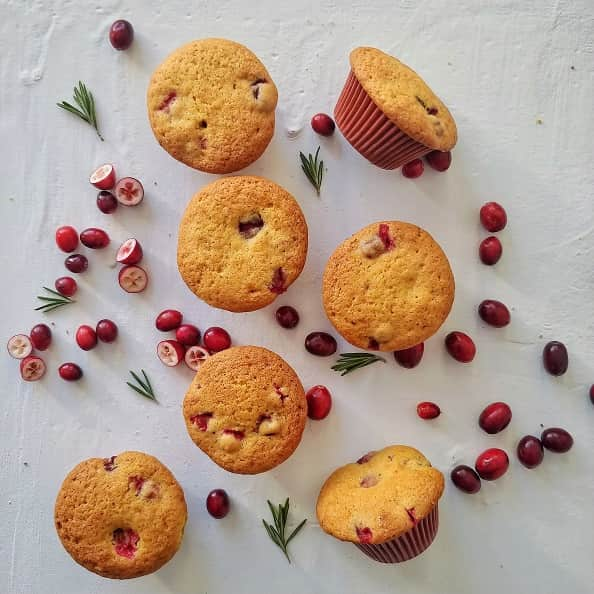 Cranberry Orange Muffin on display with fresh cranberries for decoration.