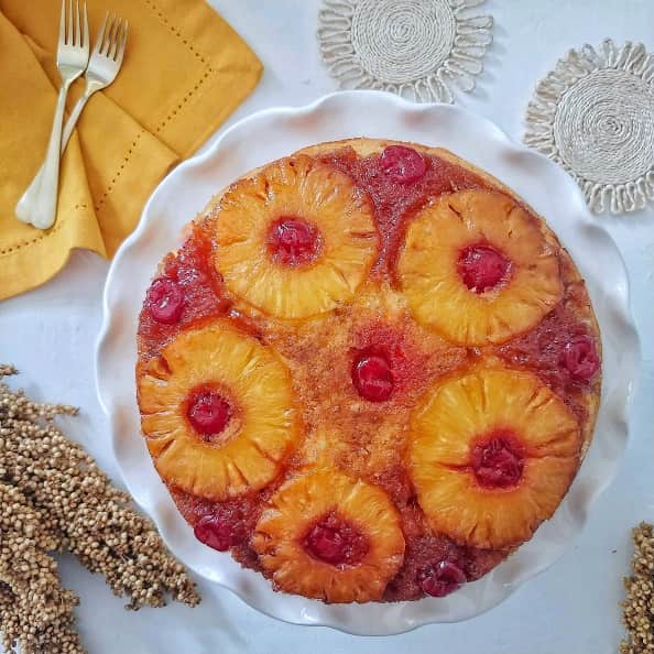 Pineapple Upside-Down Cake on a cake stand.
