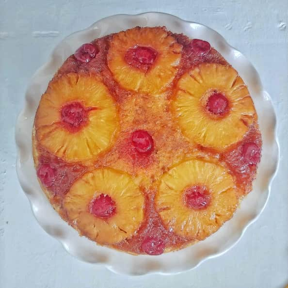 Pineapple Upside-Down Cake on a cake stand.