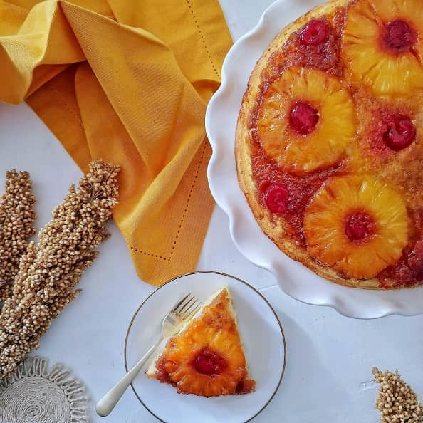 Pineapple Upside-Down Cake on a cake stand.