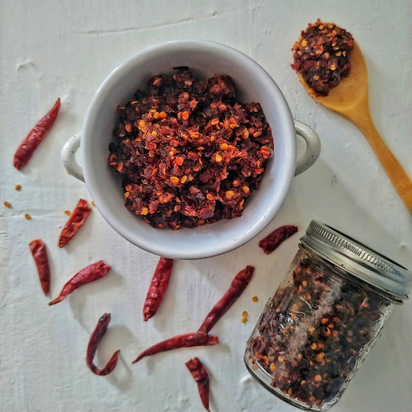 Sri Lankan Shrimp Chili Paste on display with filled up mason jar and wooden spoon.