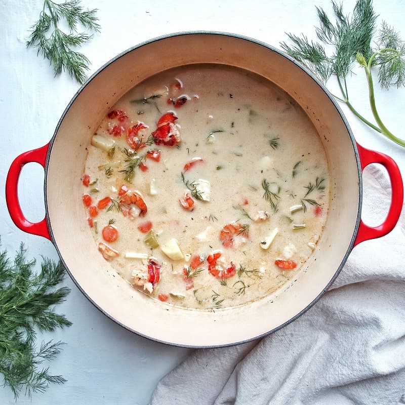 Dairy free seafood chowder in a pot on a table ready to be served.