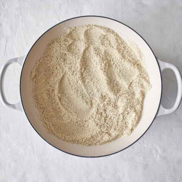 Dairy free rava Kesari preparation- le creuset braiser pan with semolina , rava, cream of wheat