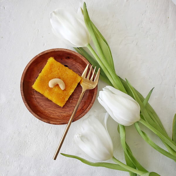 Dairy free rava Kesari / semolina dessert served on wooden plate.