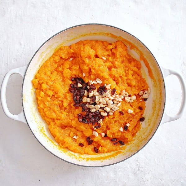 Dairy free rava Kesari preparation- le creuset braiser add raisins and cashew nuts.